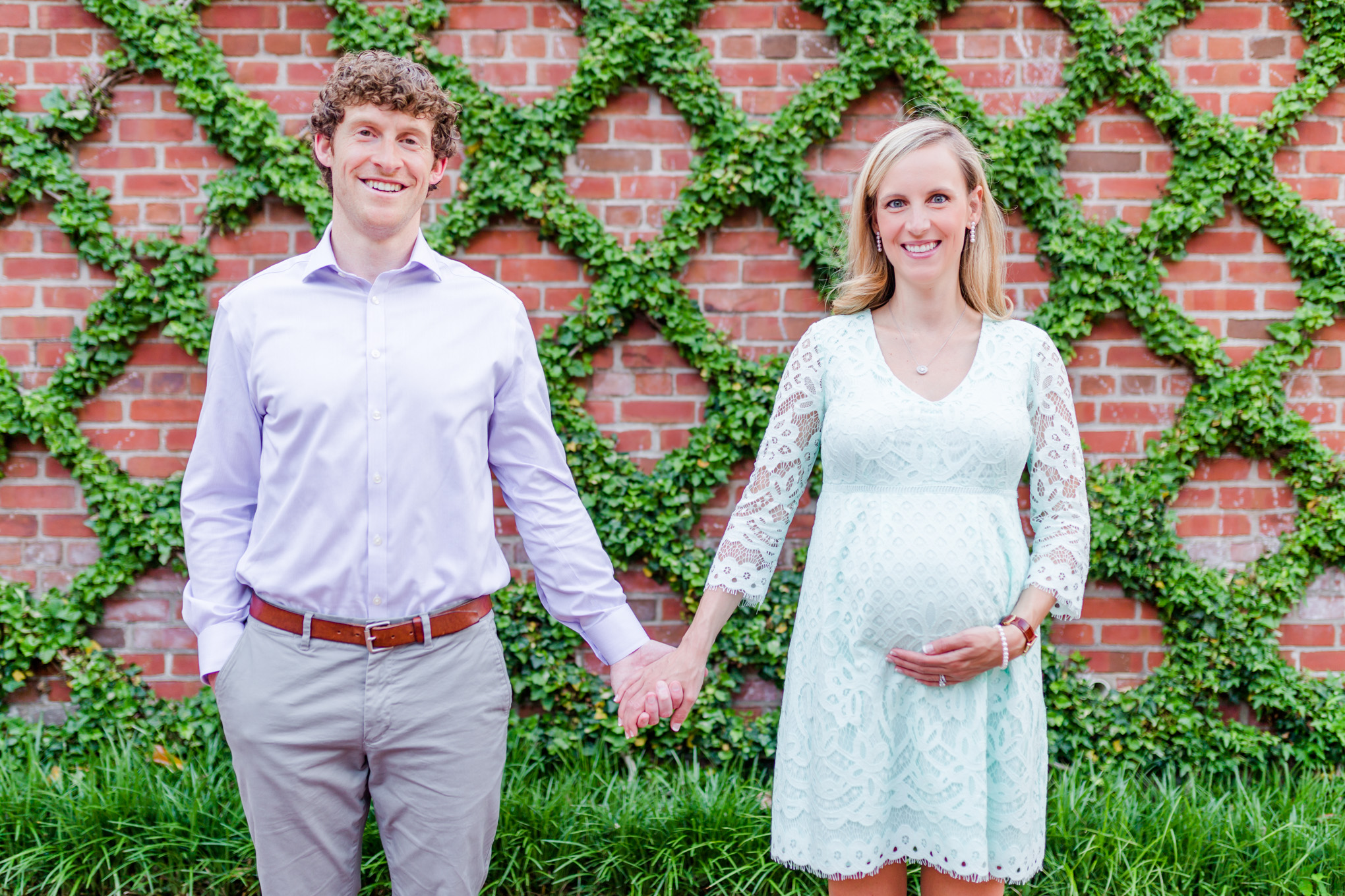 Georgetown maternity photos, married couple, pregnant woman, criss cross, plant life, garden wall, baby bump