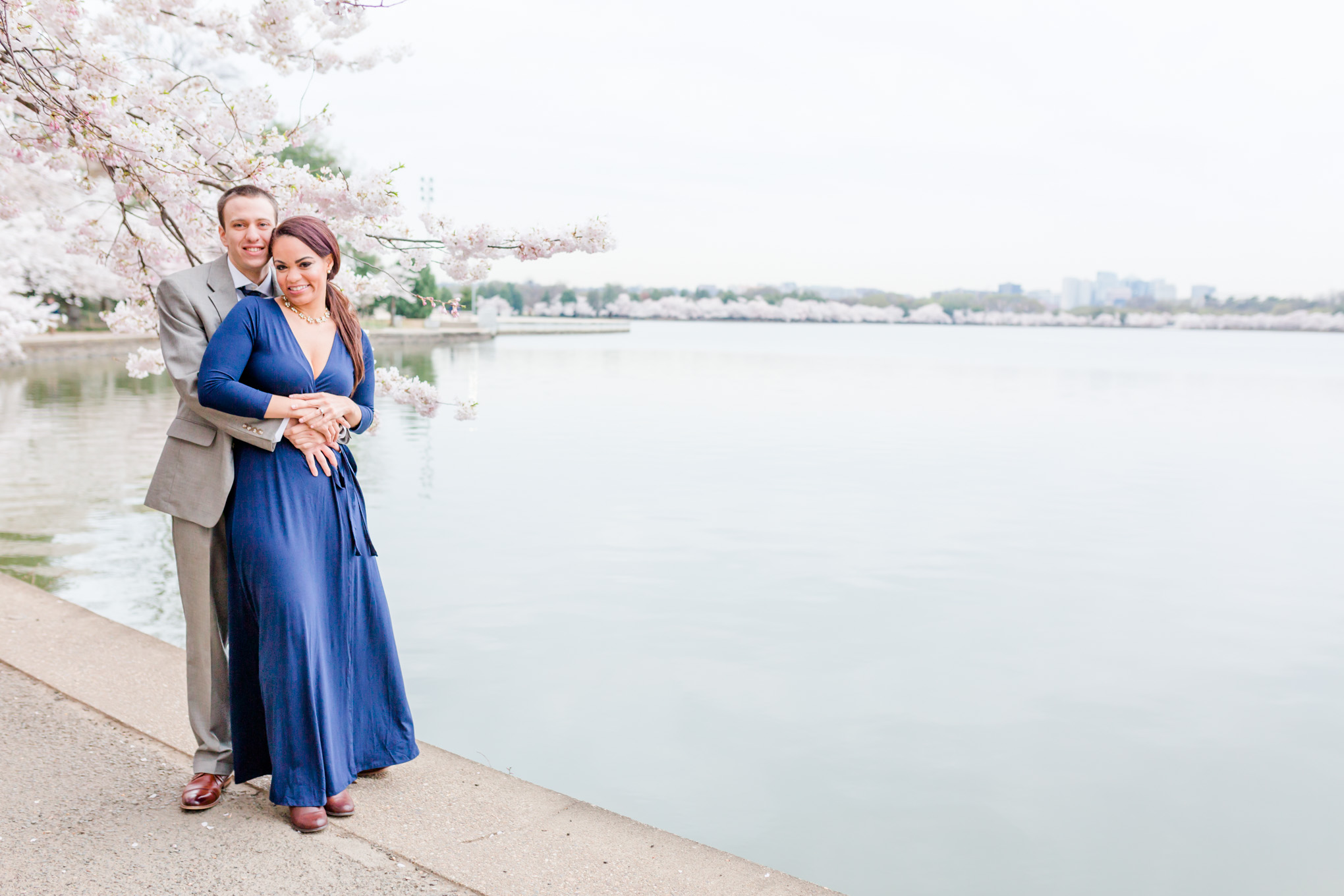 D.C. cherry blossoms engagement session, engagement session, D.C. engagement session, cherry blossoms, D.C. cherry blossoms, photo shoot outfit ideas, long navy wrap dress, long wrap dress, navy wrap dress, tidal basin, waterfront, 