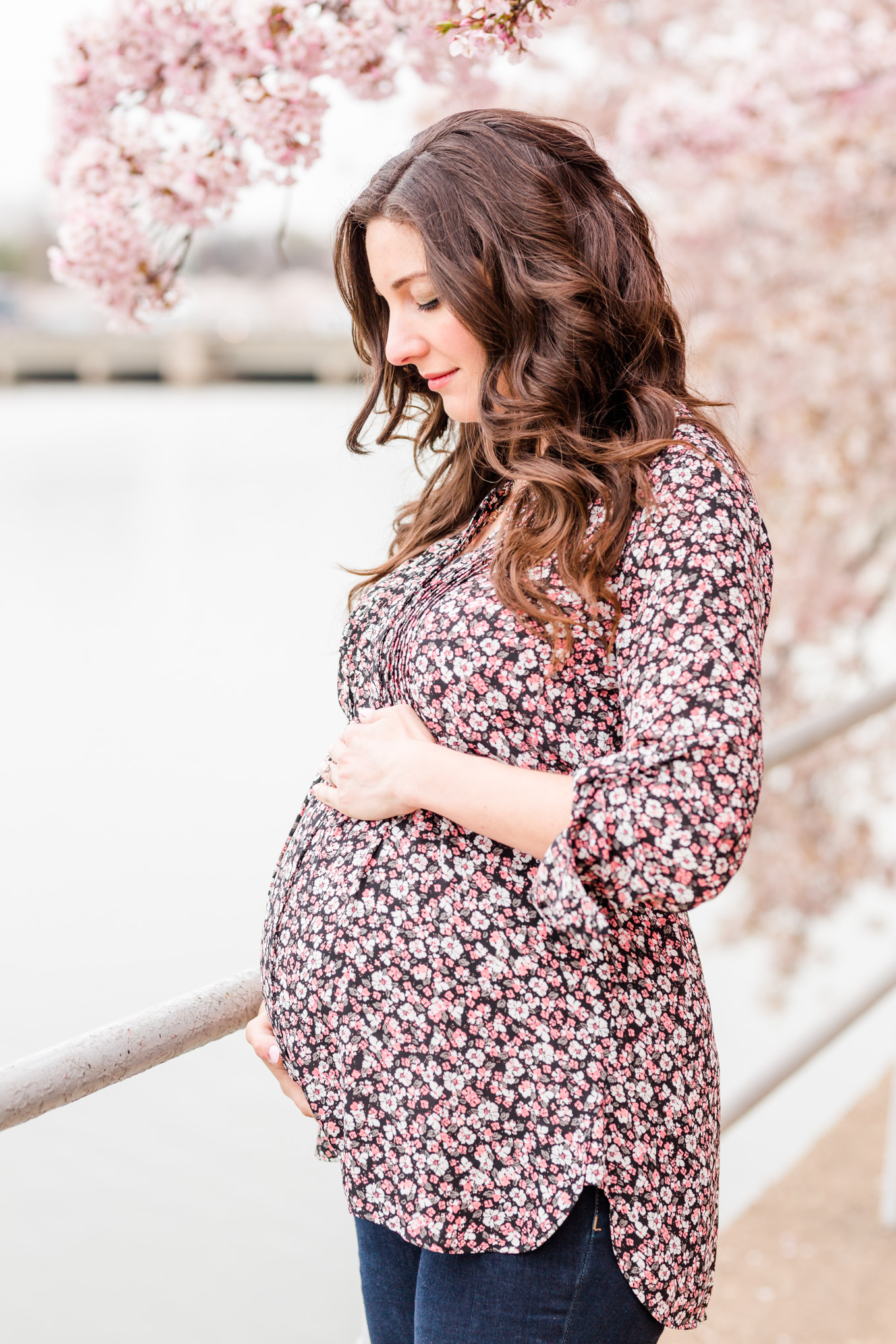 D.C. cherry blossoms maternity session, maternity portraits, maternity photos, D.C. cherry blossoms, cherry blossoms maternity photo, floral print top, brunette expectant mom, expecting mother, brunette woman, pregnant woman, third trimester, baby bump