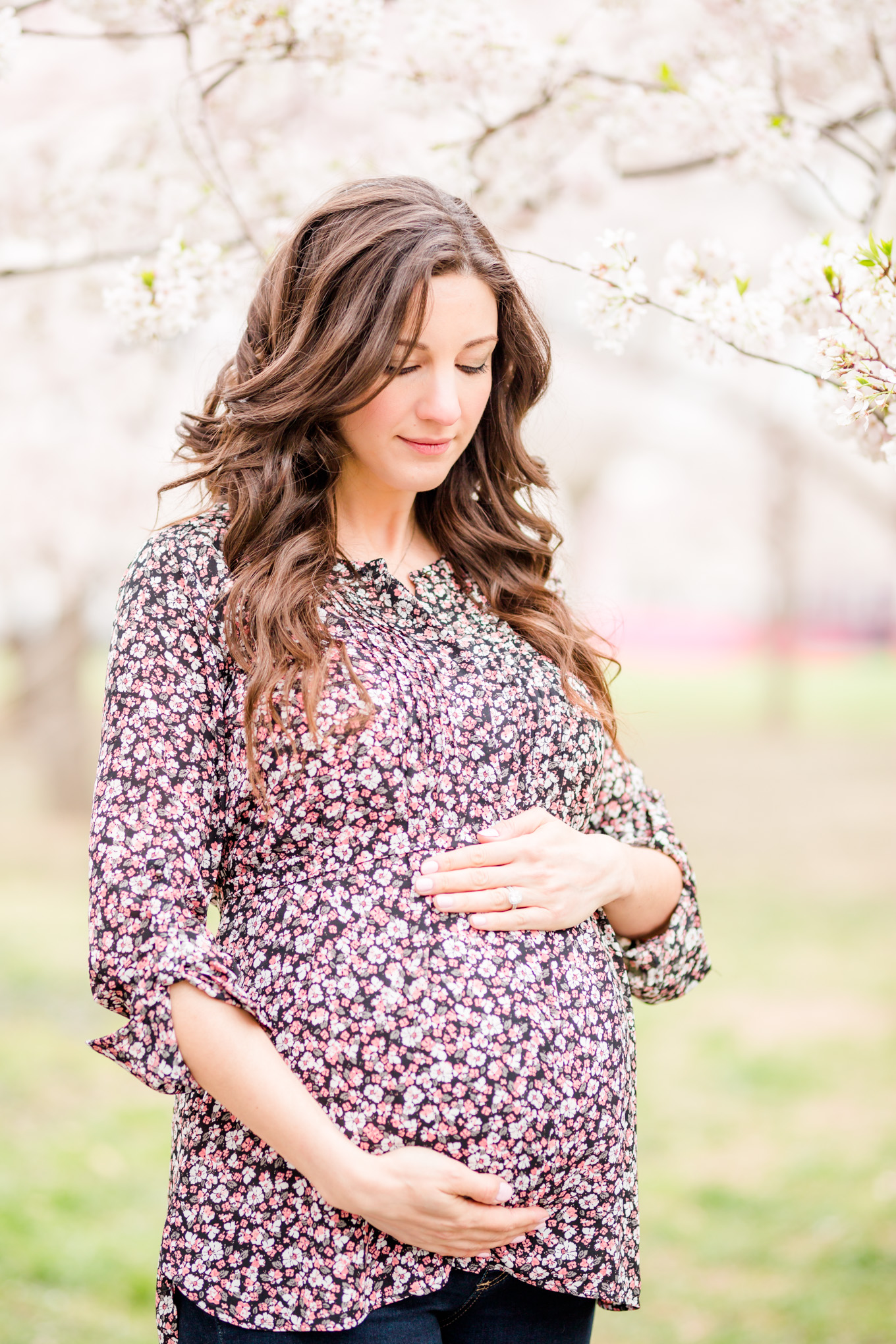 D.C. cherry blossoms maternity session, maternity portraits, maternity photos, D.C. cherry blossoms, cherry blossoms maternity photo, floral print top, brunette expectant mom, expecting mother, brunette woman, pregnant woman, third trimester, baby bump, cherry blossoms forest