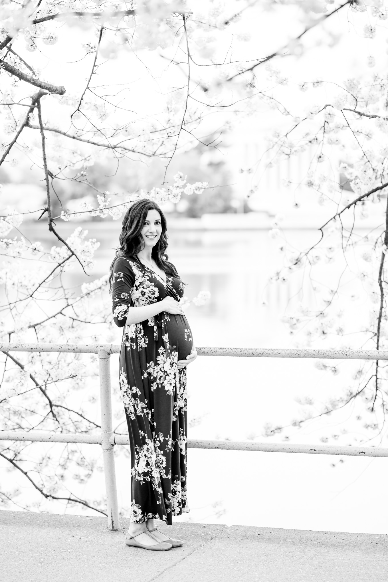 D.C. cherry blossoms maternity session, maternity portraits, maternity photos, D.C. cherry blossoms, cherry blossoms maternity photo, floral print top, brunette expectant mom, expecting mother, brunette woman, pregnant woman, third trimester, baby bump, cherry blossom print dress, black and white portrait, floral frame, Jefferson Memorial