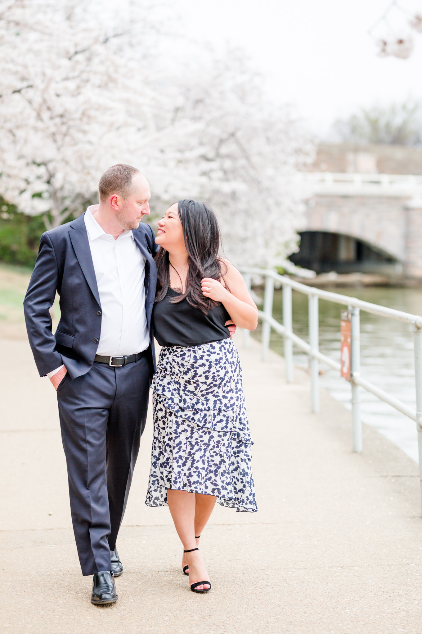 big weekend, engaged couple, engagement portraits, photo shoot outfit ideas, black and white outfits, floral skirt, navy suit, cherry blossom engagement portraits, cherry blossom portraits, cherry blossoms, DC cherry blossoms, tidal basin, DC tidal basin