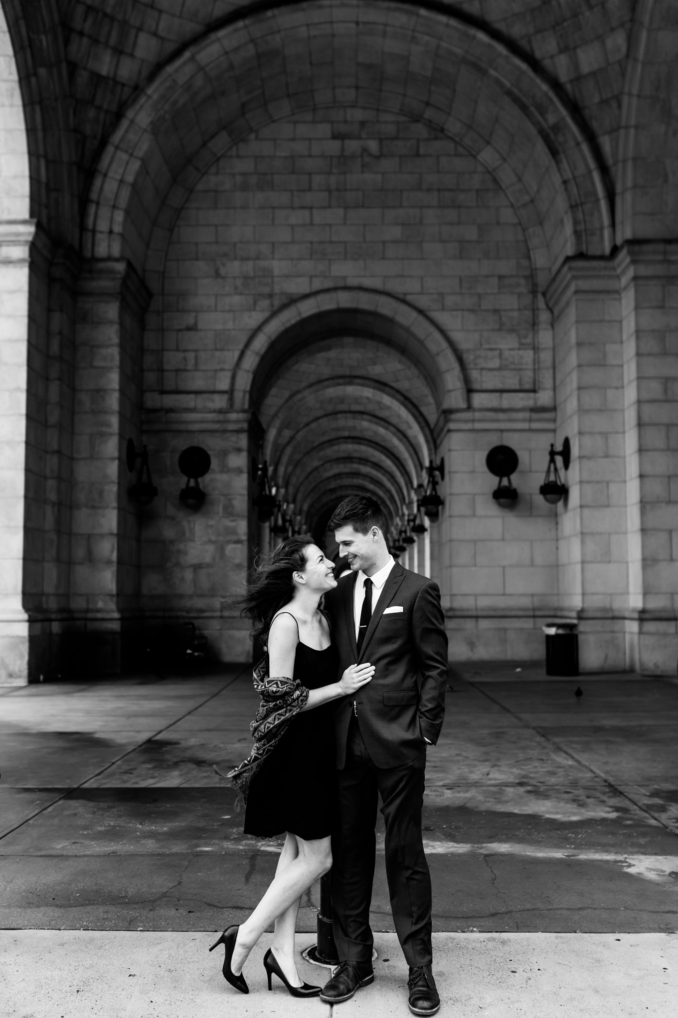 black and white engagement photos, black and white photography, black and white photos, engagement photos, black and white D.C., D.C. engagement photos, classic engagement photos, traditional engagement photos, engagement photos poses, classic architecture, D.C. architecture, Union Station D.C., Union Station, engaged couple, relationship goals, joyful couple, black and white sessions, windblown, romantic portraits, archways