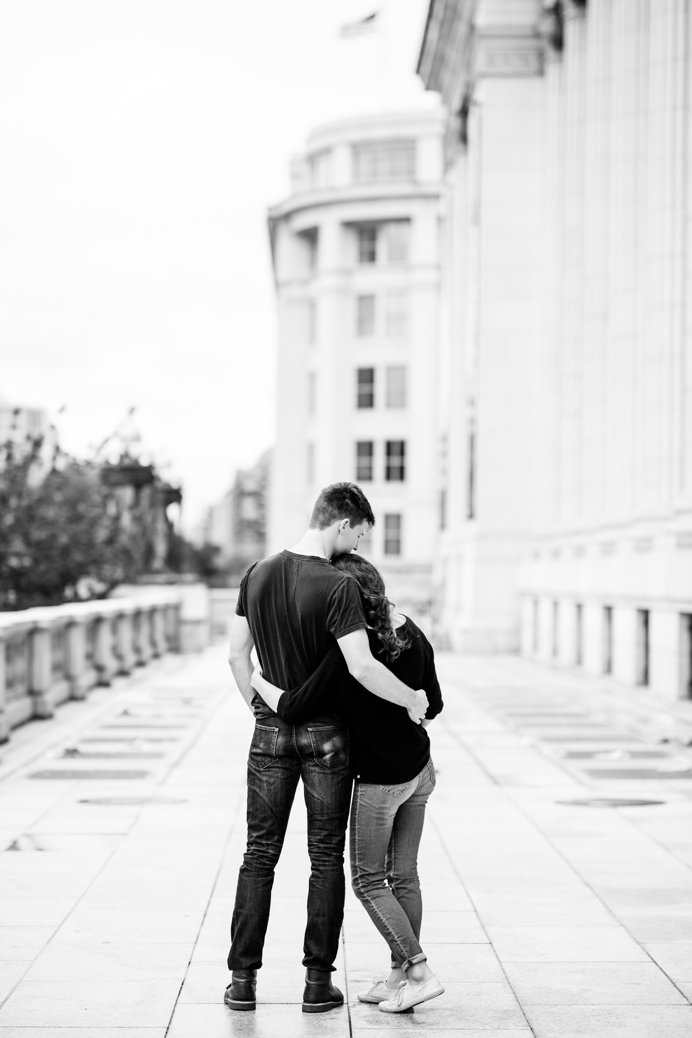 black and white engagement photos, black and white photography, black and white photos, engagement photos, black and white D.C., D.C. engagement photos, classic engagement photos, traditional engagement photos, engagement photos poses, classic architecture, D.C. architecture, Union Station D.C., Union Station, engaged couple, relationship goals, joyful couple, black and white sessions, Postal Museum, couple hugging