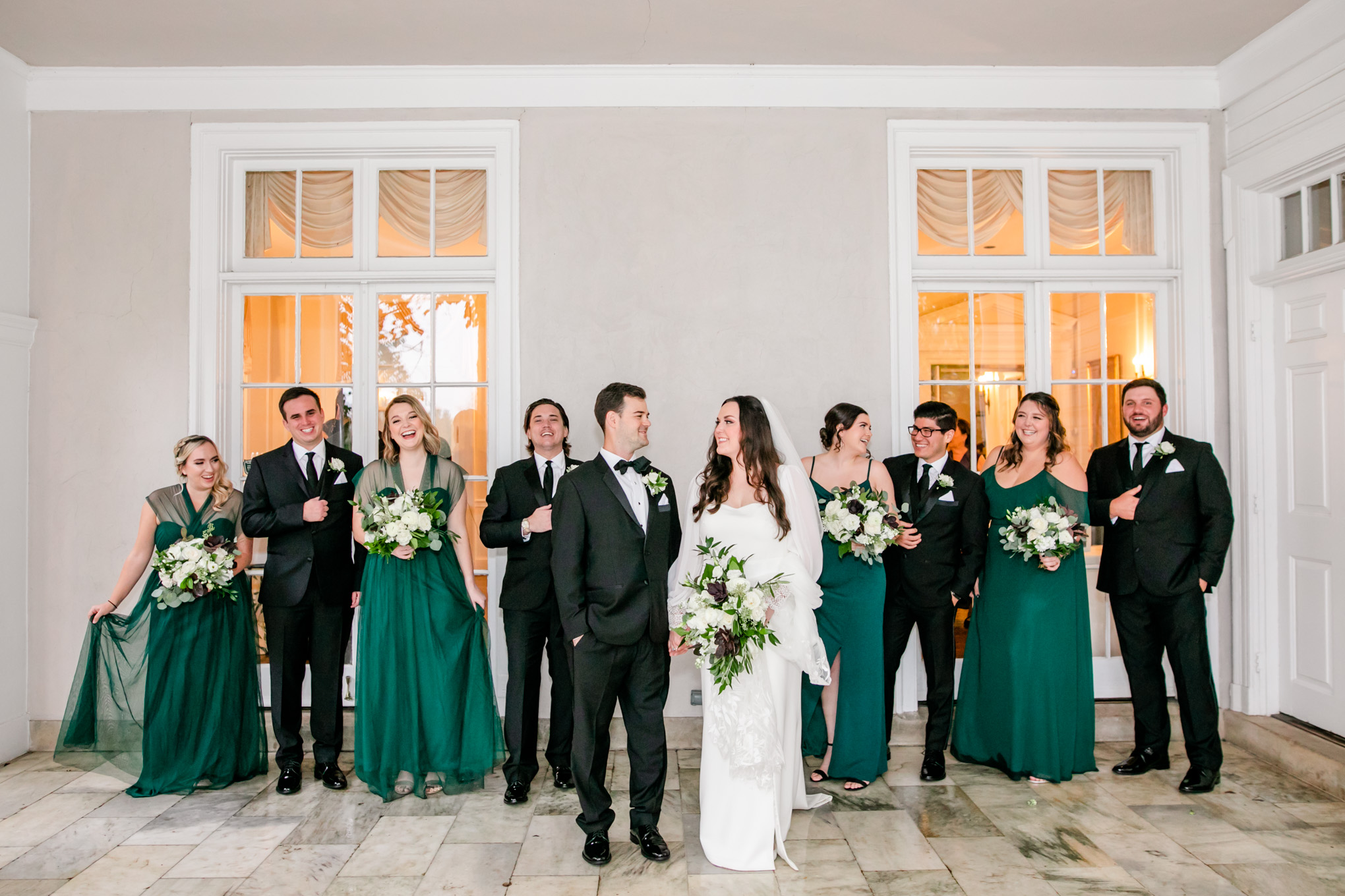 emerald and ivory Woodend Sanctuary wedding, autumn Woodend Sanctuary wedding, rainy day wedding, Maryland wedding venues, Chevy Chase MD wedding venue, mansion wedding, manor house wedding, indoor wedding, DC wedding venue, DC wedding photographer, Baltimore wedding photographer, Rachel E.H. Photography, emerald and ivory aesthetic, bride and groom with wedding party, wedding party laughing