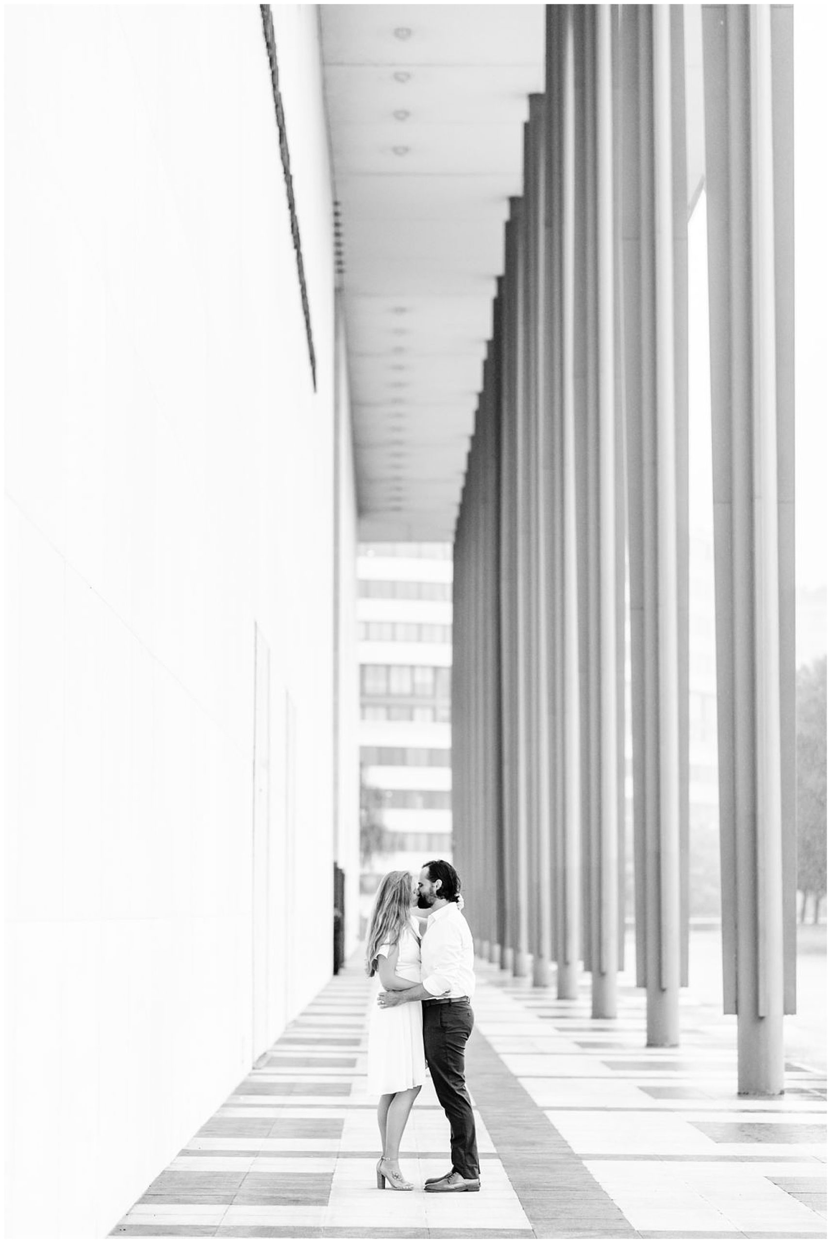rainy Kennedy Center elopement, DC elopement, rainy day portraits, rainy elopement, rainy engagement photos, playing in the rain, Washington DC wedding photographer, DC wedding photography, playful portraits, boho couple, dancing in the rain, Rachel E.H. Photography, black and white, couple kissing