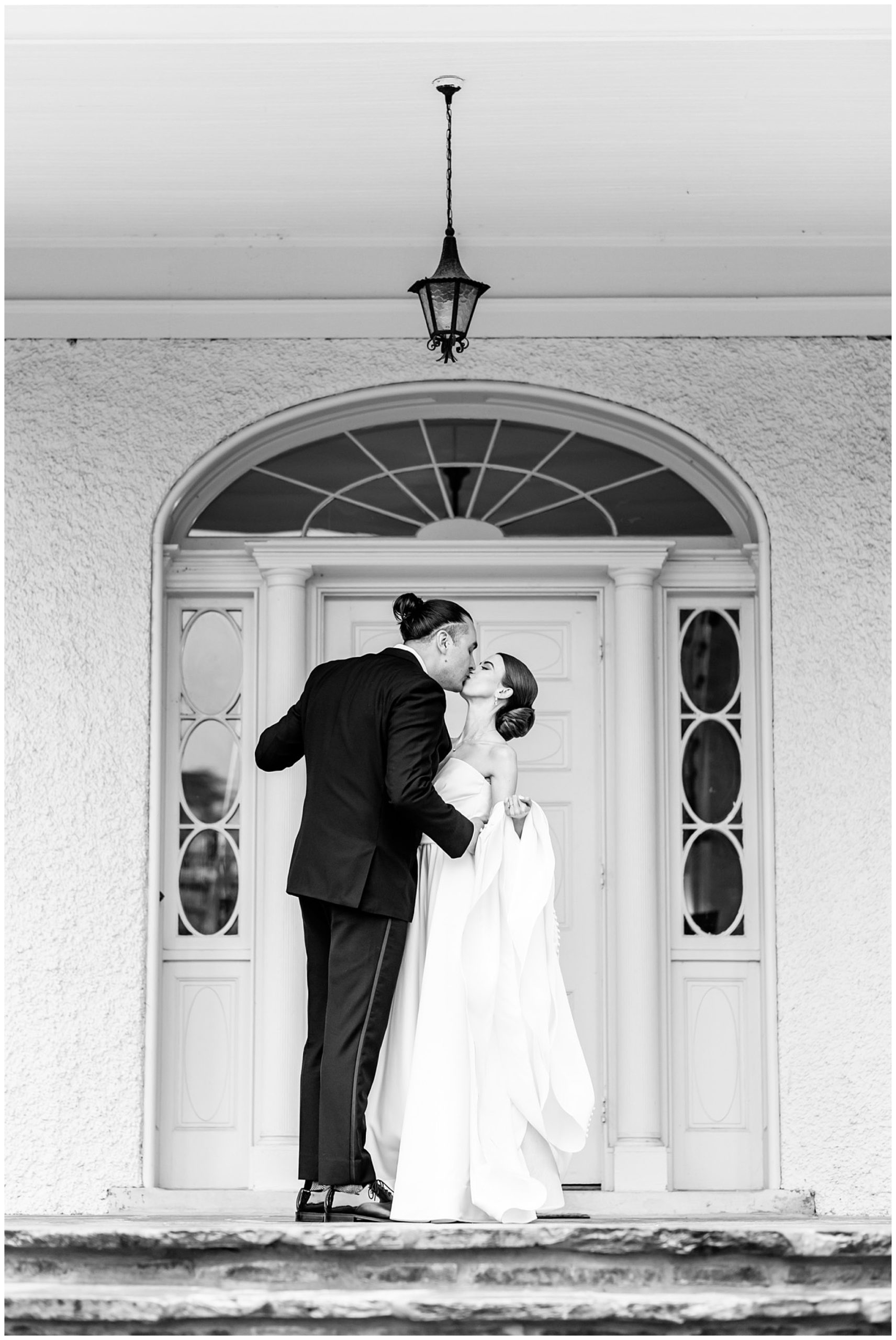 classic Rust Manor House wedding, sprig wedding, black and white aesthetic, classic wedding aesthetic, White Pumpkin Weddings City Tavern Club wedding, Leesburg wedding, Leesbur bride, manor house wedding, classic DC wedding, northern Virginia wedding venue, classic wedding venue, Washington DC wedding photographer, Rachel E.H. Photography, black and white, bride and groom kissing on porch, The Black Tux