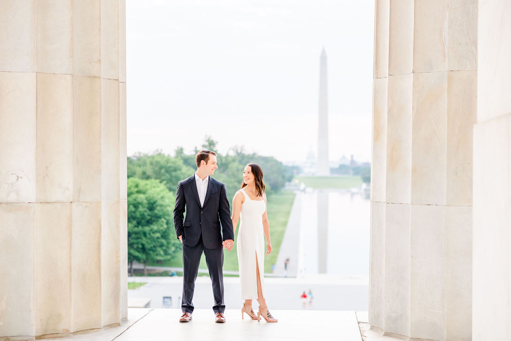 pink sunrise Lincoln Memorial engagement, DC engagement session, DC engagement photographer, formal DC engagement photos, DC elopement photographer, DC wedding photographer, classic DC engagement photos, luxury DC engagement photographer, Rachel E.H. Photography, couple holding hands, couple in between pillars