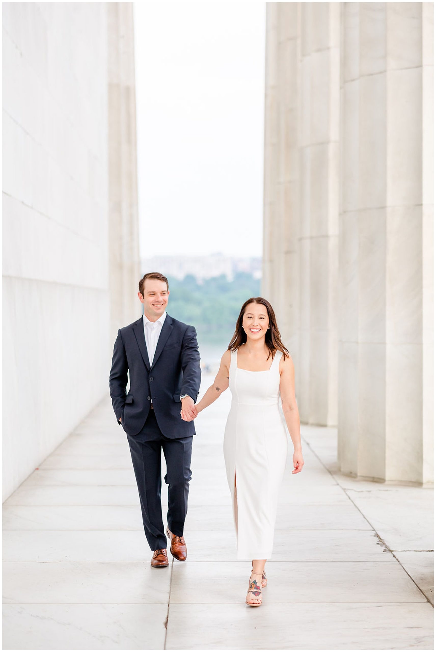 pink sunrise Lincoln Memorial engagement, DC engagement session, DC engagement photographer, formal DC engagement photos, DC elopement photographer, DC wedding photographer, classic DC engagement photos, luxury DC engagement photographer, Rachel E.H. Photography, couple holding hands from distance, woman walking towards camera, couple walking