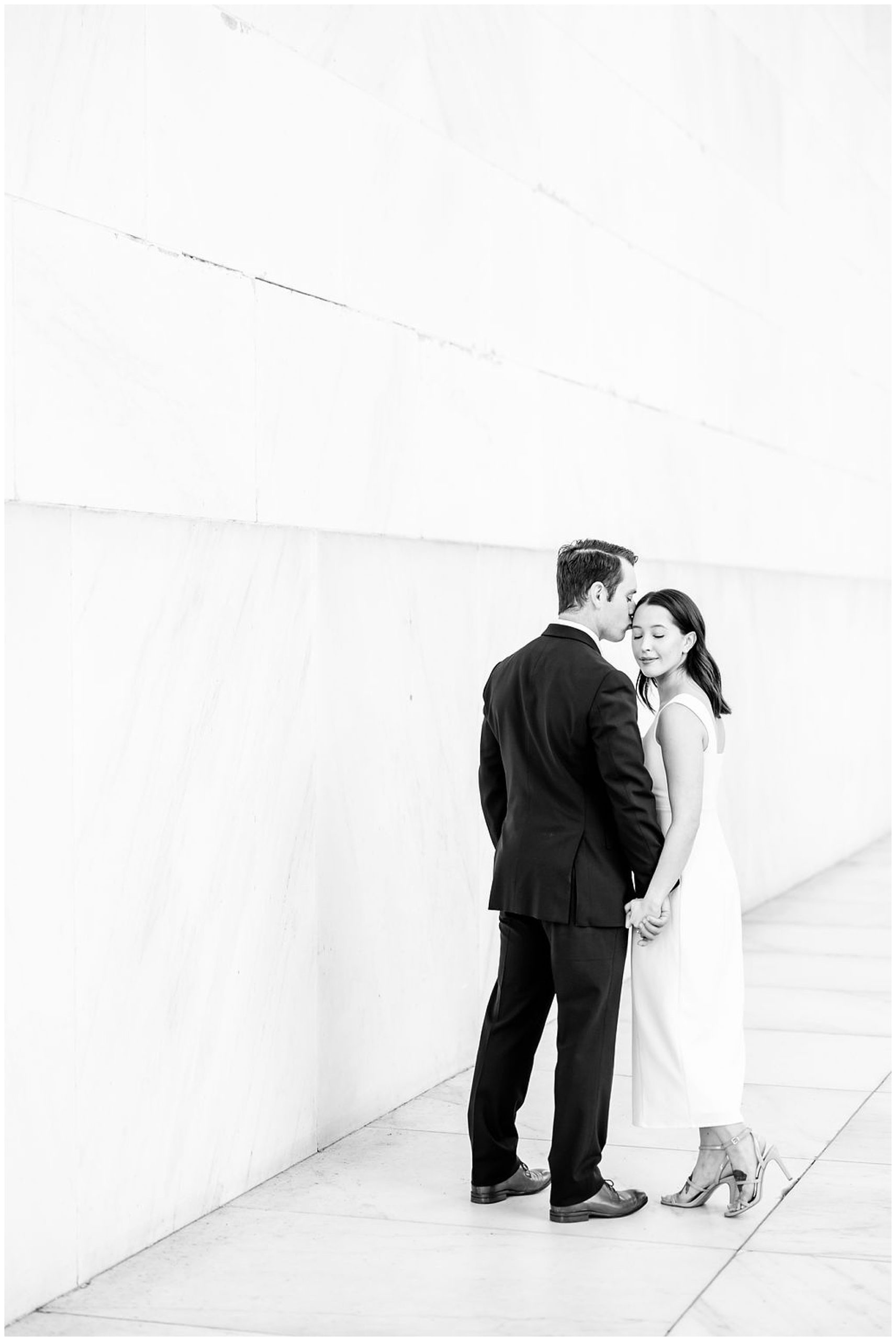 pink sunrise Lincoln Memorial engagement, DC engagement session, DC engagement photographer, formal DC engagement photos, DC elopement photographer, DC wedding photographer, classic DC engagement photos, luxury DC engagement photographer, Rachel E.H. Photography, black and white, man kissing woman's forehead