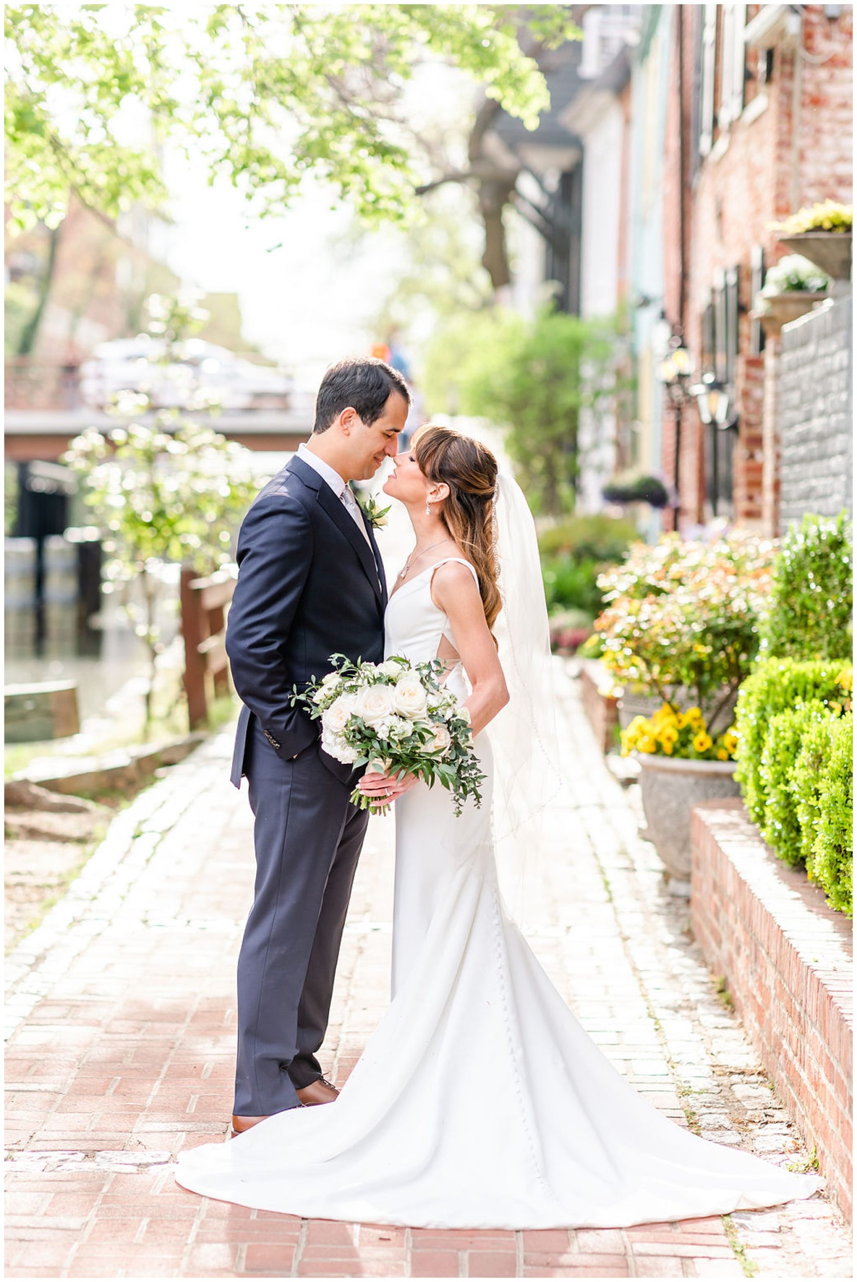spring Ritz Carlton Georgetown wedding, Georgetown DC wedding, Georgetown Bride, Georgetown couple, DC couple, DC wedding venue, spring wedding, floral focused wedding, classic DC wedding, Ritz Carlton wedding, DC wedding photographer, Georgetown wedding photographer, Rachel E.H. Photography, bride and groom on brick path, bride and groom touching noses and closing eyes