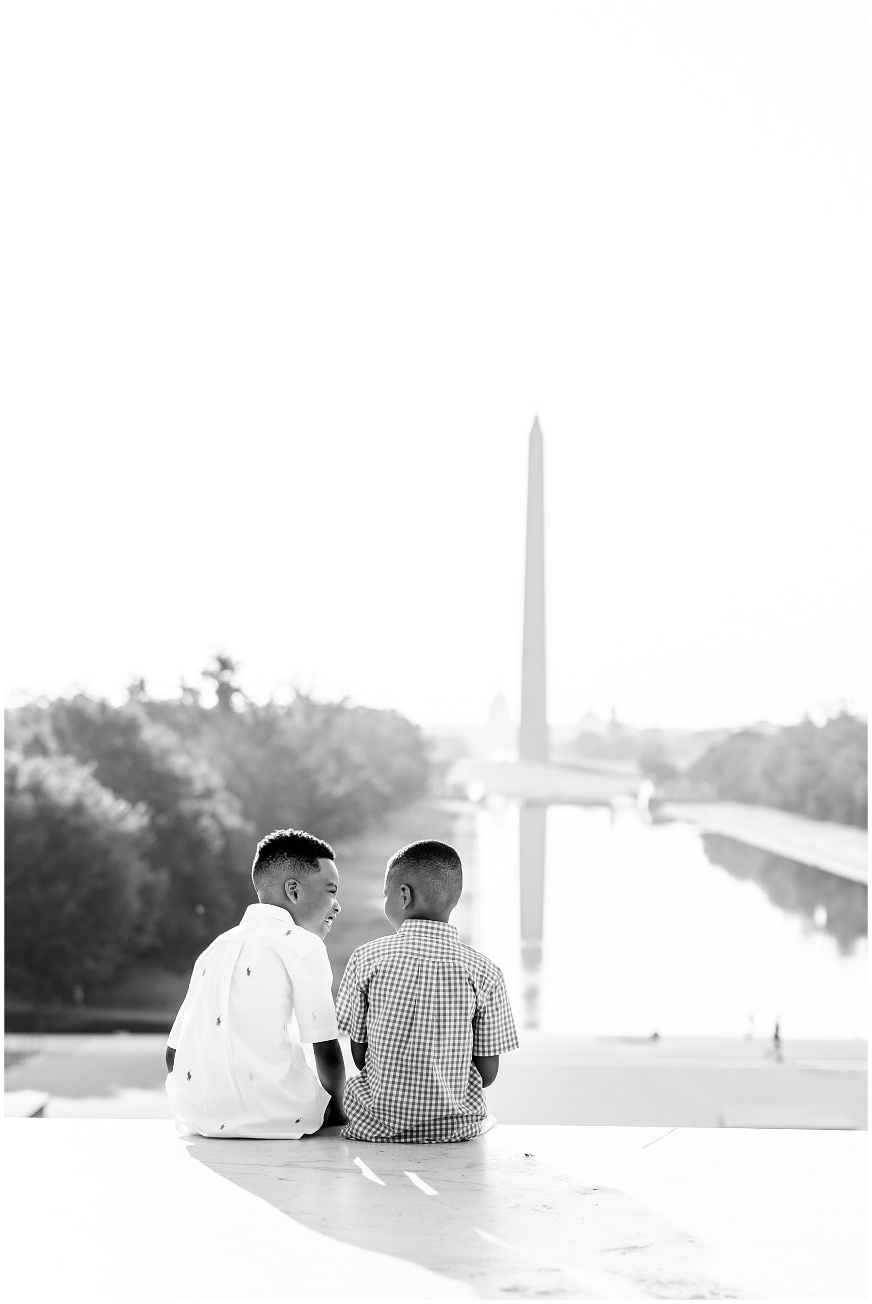summer Lincoln Memorial family photos, Lincoln Memorial portraits, DC family photos, National Mall family photos, summer of four, family portrait poses, Lincoln Memorial portraits, DC family photographer, Rachel E.H. Photography, black and white, brothers sitting on steps, brothers laughing