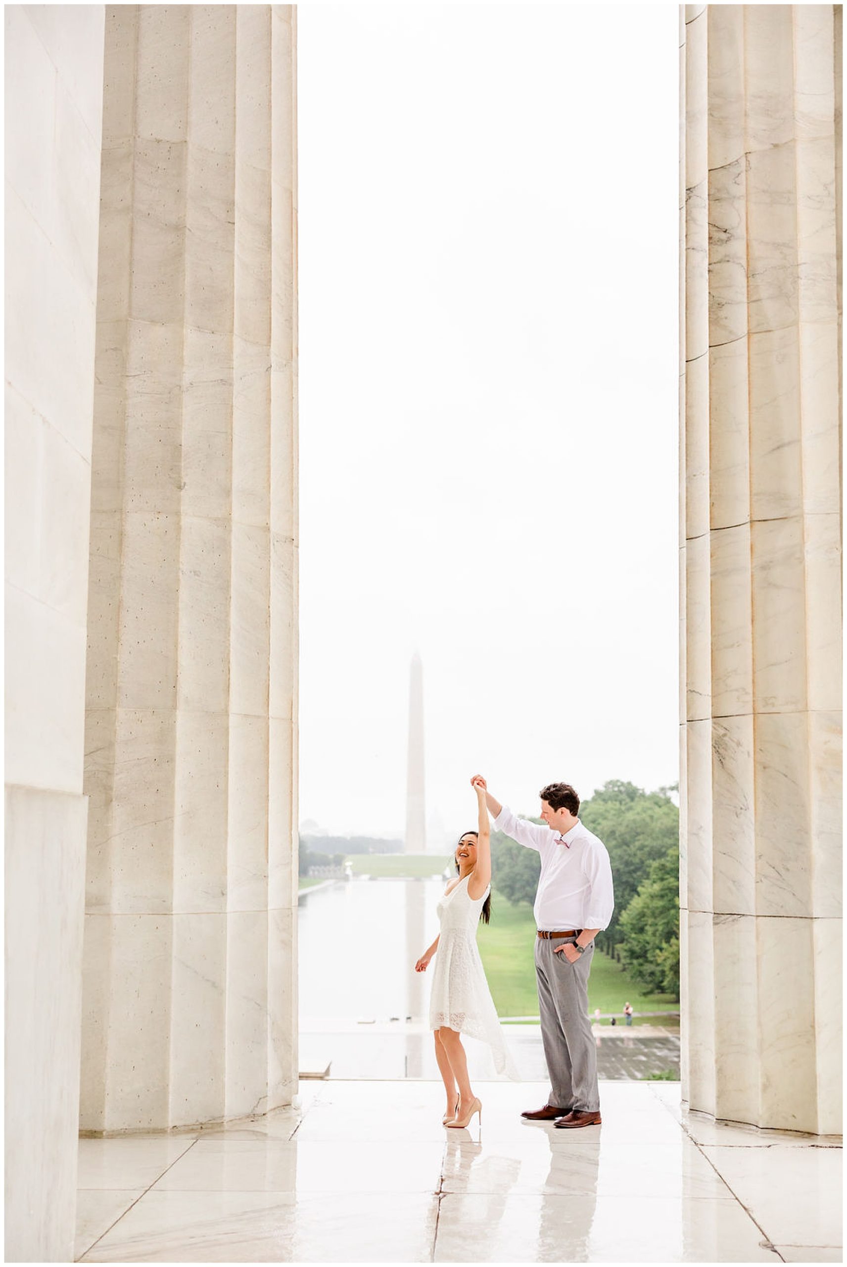 sunrise and sunset DC wedding, DC wedding photos, DC wedding portraits, micro-wedding, DC micro-wedding photography, DC micro-wedding photographer, DC petite wedding photographer, northern Virginia wedding photography, natural light wedding photography, unique wedding, Rachel E.H. Photography, man twirling woman, couple in between large marble pillars, off the shoulder white dress