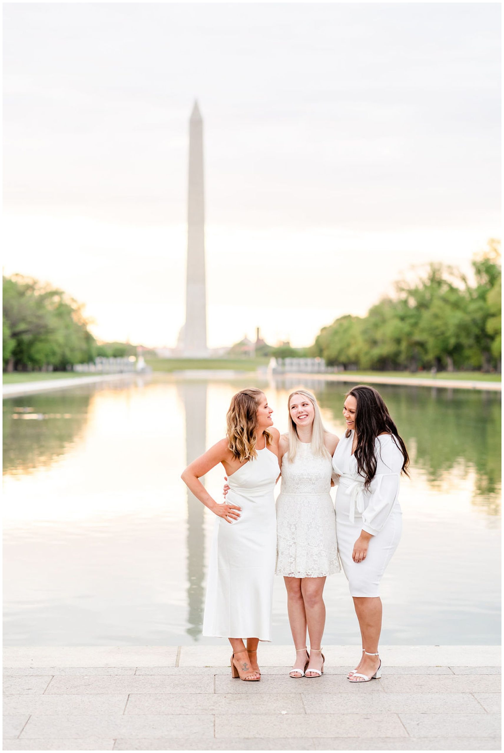 Marymount group graduation photos, LIncoln Memorial group graduation phtoos, Lincoln Memorial graduation photos, Lincoln memorial portraits, D.C. graduates, Washington D.C. universities, Marymount University graduates, Rachel E.H. Photography, three woman smiling, women laughing with each other, women in front of reflecting pool
