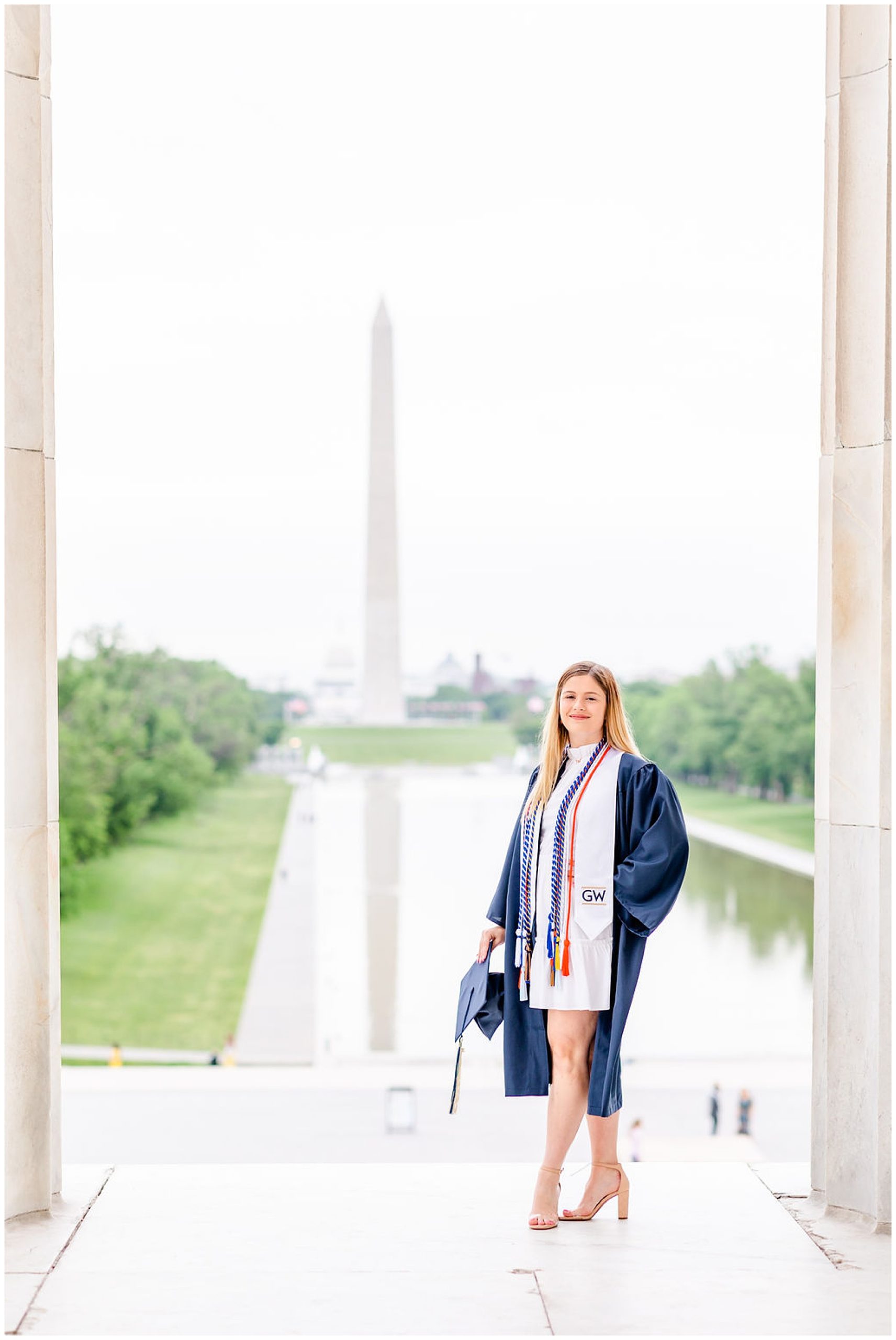 sister graduation photo session, Lincoln Memorial graduation photos, sibling graduation photos, magic hour graduation photos, Washington D.C. graduation photos, D.C graduates, Rachel E.H. Photographer, D.C. graduation photographer, woman with multiple cords, graduation stole and cords, woman wearing graduation gown, navy graduation gown