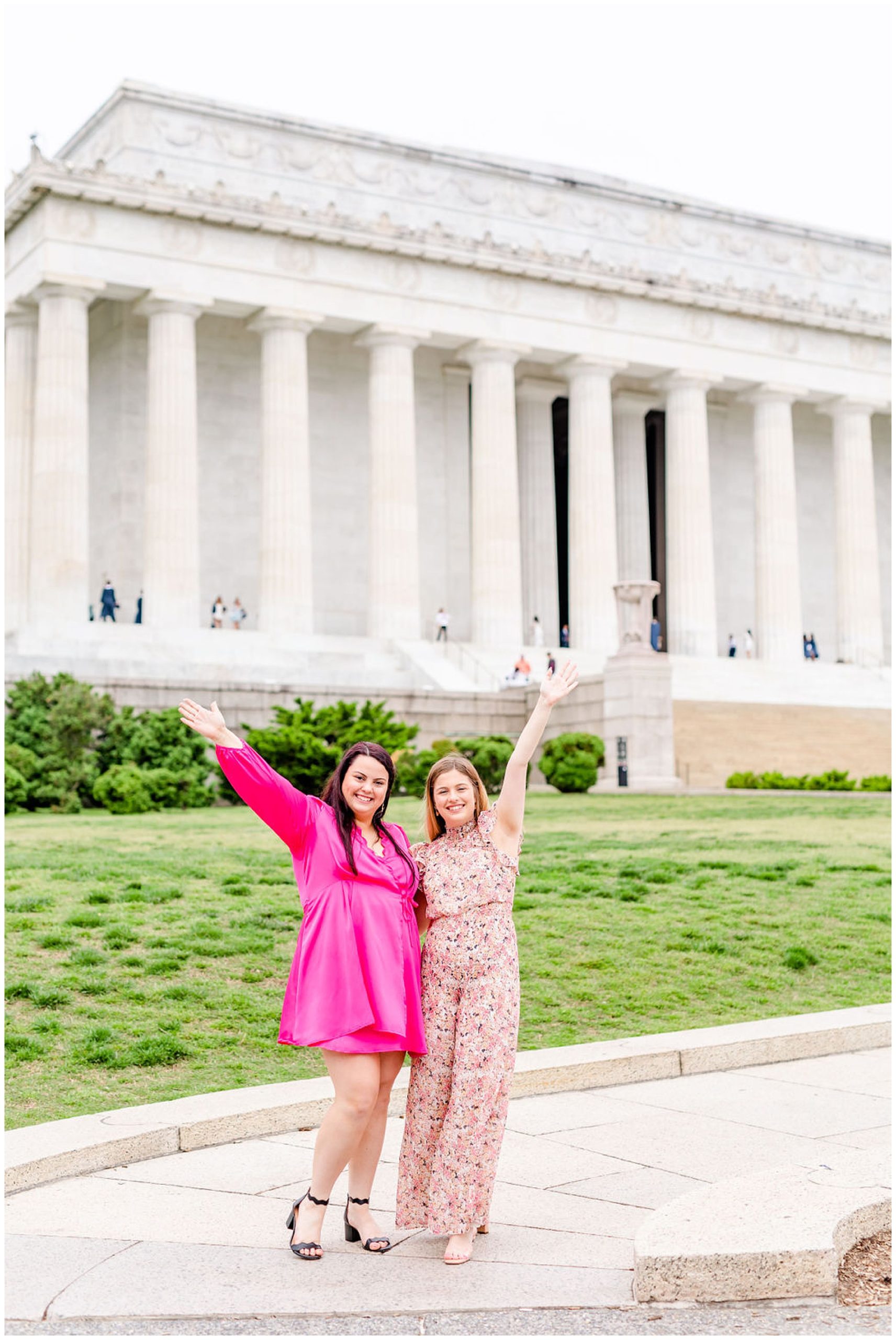 sister graduation photo session, Lincoln Memorial graduation photos, sibling graduation photos, magic hour graduation photos, Washington D.C. graduation photos, D.C graduates, Rachel E.H. Photographer, D.C. graduation photographer, bright pink dress, two sisters, lawn in front of Lincoln memorial, sisters graduating