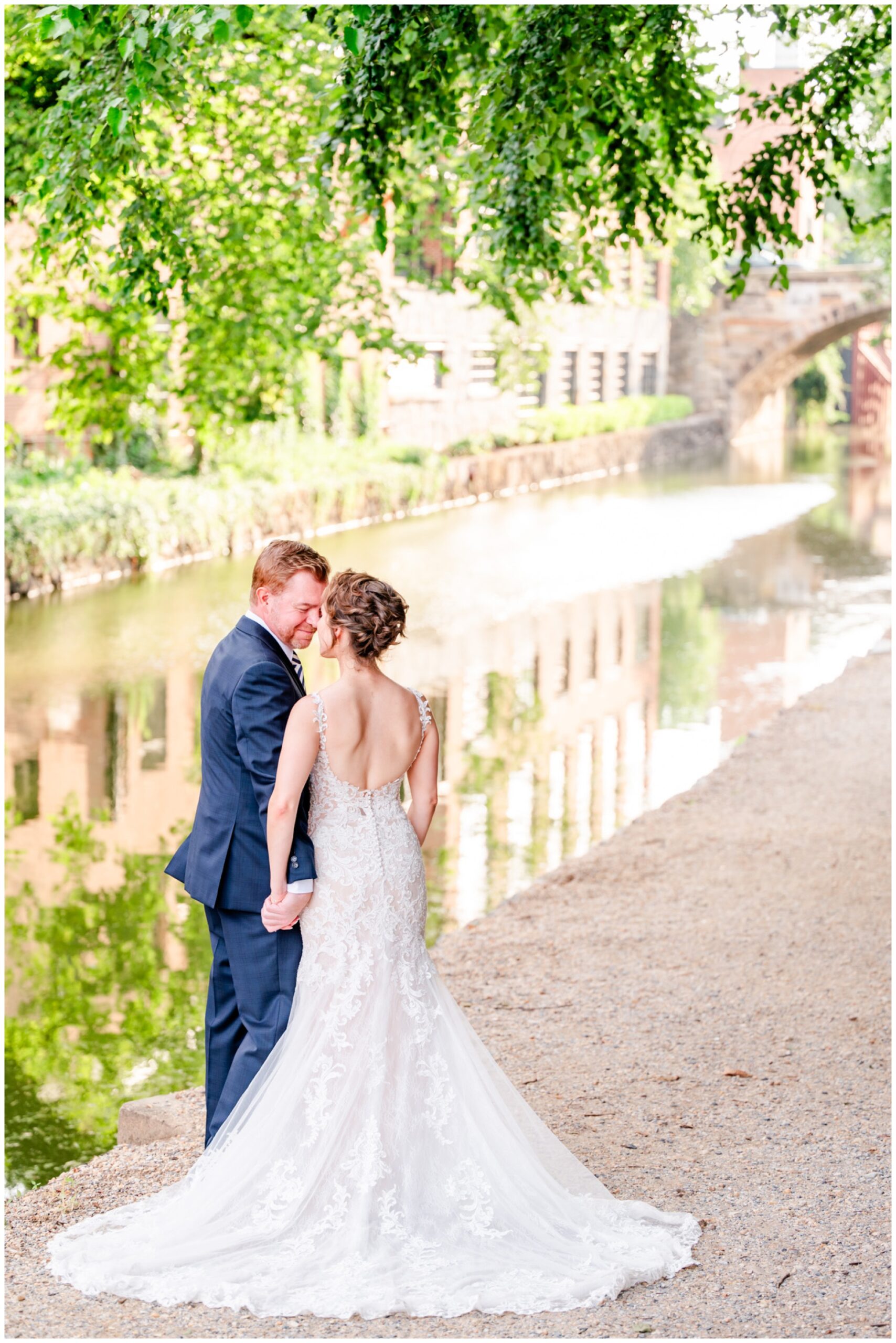romantic Ritz Carlton Georgetown wedding, summer wedding aesthetic, green and white aesthetic, summer D.C. wedding, D.C. wedding venues, Ritz Carlton wedding, Washington D.C. wedding, romantic wedding aesthetic, Georgetown wedding, Rachel E.H. Photography, D.C. photographer, couple laughing together, backless wedding dress, couple in front of canal